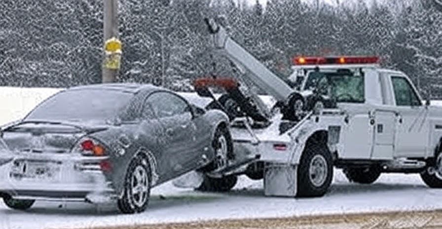 Tow truck assisting broken down vehicle